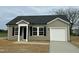 Charming single-story home featuring a covered entry, black shutters, and an attached one-car garage at 114 Johnson Ridge Way, Four Oaks, NC 27524