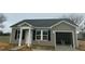 Charming single-story home features vinyl siding, black shutters, and an attached one-car garage at 114 Johnson Ridge Way, Four Oaks, NC 27524