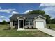Charming single-story home with vinyl siding, black shutters, and a well-manicured front yard at 114 Johnson Ridge Way, Four Oaks, NC 27524