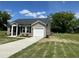Charming single-story home with vinyl siding, black shutters, and a well-manicured front yard at 114 Johnson Ridge Way, Four Oaks, NC 27524