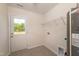 Bright laundry room with a door to the backyard, a shelf and connections for the washer and dryer at 114 Johnson Ridge Way, Four Oaks, NC 27524