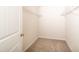 A practical walk-in closet space with wire shelving and carpeted floor at 114 Johnson Ridge Way, Four Oaks, NC 27524