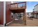 View of a home's back porch and backyard area, framed by wood supports and bare landscaping at 114 Journey Pl, Durham, NC 27703