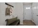 Cozy entryway featuring a bench, wall hooks, and a bright white door at 114 Journey Pl, Durham, NC 27703