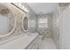Bathroom with a white vanity, two mirrors, and floral wallpaper at 115 Perth Pl, Durham, NC 27712