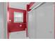 Bright red bathroom featuring a shower with sliding doors, a window, and white hexagon tile floors at 115 Perth Pl, Durham, NC 27712