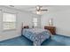 Bedroom with blue carpet and white walls, featuring two windows at 115 Perth Pl, Durham, NC 27712