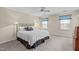 Bright bedroom with white bedding, soft lighting, and floral window shades at 115 Perth Pl, Durham, NC 27712