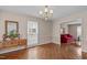 Elegant dining room with patterned wallpaper, hardwood floors, and ample natural light at 115 Perth Pl, Durham, NC 27712