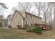 The exterior back of a two-story home with a deck and walkout basement at 115 Perth Pl, Durham, NC 27712