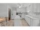 Bright white kitchen with modern appliances, ample counter space, and eat-in dining area at 115 Perth Pl, Durham, NC 27712