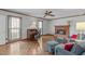 Inviting living room with brick fireplace, hardwood floors, and large windows offering natural light at 115 Perth Pl, Durham, NC 27712