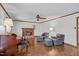 Cozy living room with a brick fireplace, hardwood floors, and comfortable seating arrangement at 115 Perth Pl, Durham, NC 27712