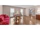 Bright living room with hardwood floors, large windows, and comfortable seating arrangement at 115 Perth Pl, Durham, NC 27712