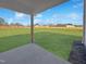 View from the covered patio reveals a large, fenced backyard with a well-maintained lawn at 120 Whistling Way # Cary Traditiol, Lillington, NC 27546