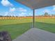 Covered patio with a view of the spacious, fenced backyard and lawn, perfect for outdoor relaxation at 120 Whistling Way # Cary Traditiol, Lillington, NC 27546