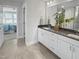 Bathroom with dual sinks, white cabinetry, and a view to the bedroom at 120 Whistling Way # Cary Traditiol, Lillington, NC 27546