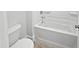 Bathroom featuring a white tiled tub and toilet at 120 Whistling Way # Cary Traditiol, Lillington, NC 27546