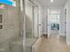 Modern bathroom featuring tile shower, glass door, tile flooring, and a view into bedroom at 120 Whistling Way # Cary Traditiol, Lillington, NC 27546