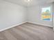 Clean, carpeted bedroom with a large window offering scenic outdoor views at 120 Whistling Way # Cary Traditiol, Lillington, NC 27546