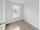 This bedroom features a neutral carpet, white walls, and a window with a view of the neighborhood at 120 Whistling Way # Cary Traditiol, Lillington, NC 27546