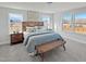 Well-lit bedroom with large windows, modern decor, a stylish bed, and an accent bench at 120 Whistling Way # Cary Traditiol, Lillington, NC 27546