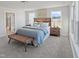 Bright bedroom featuring large windows, a stylish bed, and a modern bench at 120 Whistling Way # Cary Traditiol, Lillington, NC 27546