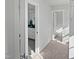 Hallway view to bathroom and laundry with tile floors at 120 Whistling Way # Cary Traditiol, Lillington, NC 27546