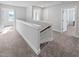 Upstairs hallway showcasing neutral carpeting, white trim, and natural lighting at 120 Whistling Way # Cary Traditiol, Lillington, NC 27546