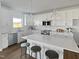 Well-lit kitchen with white cabinets, stainless steel appliances, large island with seating, and stylish pendant lighting at 120 Whistling Way # Cary Traditiol, Lillington, NC 27546