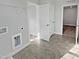 Bright laundry room with tile floors, wire shelving, and washer/dryer connections at 120 Whistling Way # Cary Traditiol, Lillington, NC 27546