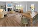 Open-concept living and dining area with wood floors, fireplace, and bright windows at 120 Whistling Way # Cary Traditiol, Lillington, NC 27546