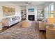 Inviting living room featuring a fireplace, comfortable seating, stylish decor, and ample natural light through large windows at 120 Whistling Way # Cary Traditiol, Lillington, NC 27546