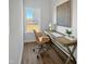 Bright home office with wood desk, comfortable chair, modern art, and large window with view of the yard at 120 Whistling Way # Cary Traditiol, Lillington, NC 27546