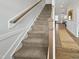 Carpeted staircase with wood trim and white walls leading to the upper level at 120 Whistling Way # Cary Traditiol, Lillington, NC 27546