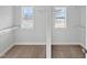 Bright walk-in closet with carpet, white walls, wire shelving, and natural light from two windows at 120 Whistling Way # Cary Traditiol, Lillington, NC 27546