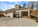 Backyard view featuring brick patio and deck with large sunroom with many windows at 1208 Anora Dr, Apex, NC 27502