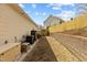 Narrow side yard with AC unit, generator, and retention wall at 1208 Anora Dr, Apex, NC 27502