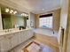 Spacious bathroom with soaking tub, large vanity, and neutral decor at 1208 Anora Dr, Apex, NC 27502