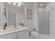 Clean bathroom with a single vanity, toilet, and glass-door shower at 1208 Anora Dr, Apex, NC 27502