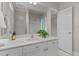 Bright bathroom features a white vanity, framed mirror, and separate shower area at 1208 Anora Dr, Apex, NC 27502
