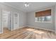 Well-lit bedroom featuring hardwood floors, a ceiling fan, and a window at 1208 Anora Dr, Apex, NC 27502