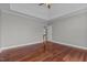 Large bedroom featuring hardwood floors, tray ceiling, and an open doorway at 1208 Anora Dr, Apex, NC 27502