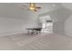 Large, versatile bonus room featuring carpet flooring, a ceiling fan, and a Ping-Pong table at 1208 Anora Dr, Apex, NC 27502
