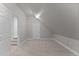 Bonus room with neutral walls and carpet features a closet and door to lower level at 1208 Anora Dr, Apex, NC 27502