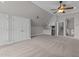 Large bonus room features neutral walls and carpet, kitchenette, and stairs to lower level at 1208 Anora Dr, Apex, NC 27502