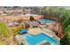 Community pool and tennis courts with a large pond in the background at 1208 Anora Dr, Apex, NC 27502