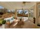 Inviting covered patio featuring comfortable seating, ceiling fans, and an open view of the backyard and landscaping at 1208 Anora Dr, Apex, NC 27502