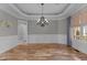 Elegant dining room featuring hardwood floors, detailed molding, and a modern chandelier at 1208 Anora Dr, Apex, NC 27502