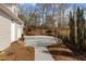 Long concrete driveway leads to an attached garage and parking area at 1208 Anora Dr, Apex, NC 27502